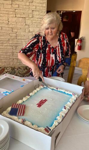 club's first lady, Judy, cutting the cake