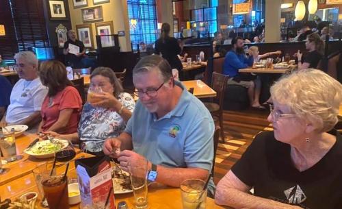 Cheering on her husband for eating the whole rack of ribs