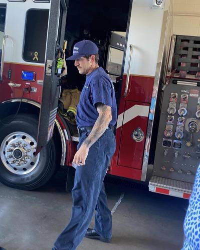 fire fighter showing us how they prepare for a fire; all the gear they have to ware.  